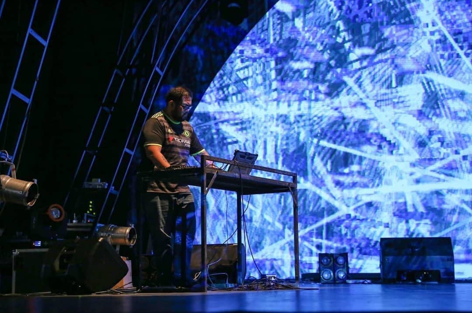 Matrix Studies performed live, close view of the performer at the laptop with projected visuals behind.
