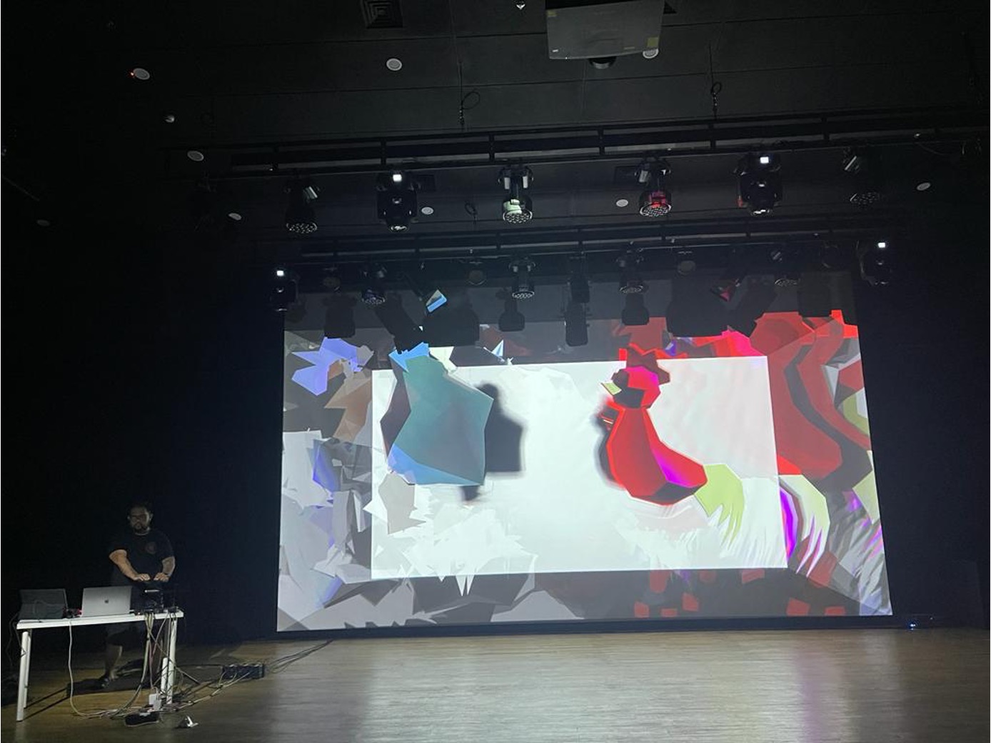 Ciung Wanara live performance — rooster avatars projected on a large screen